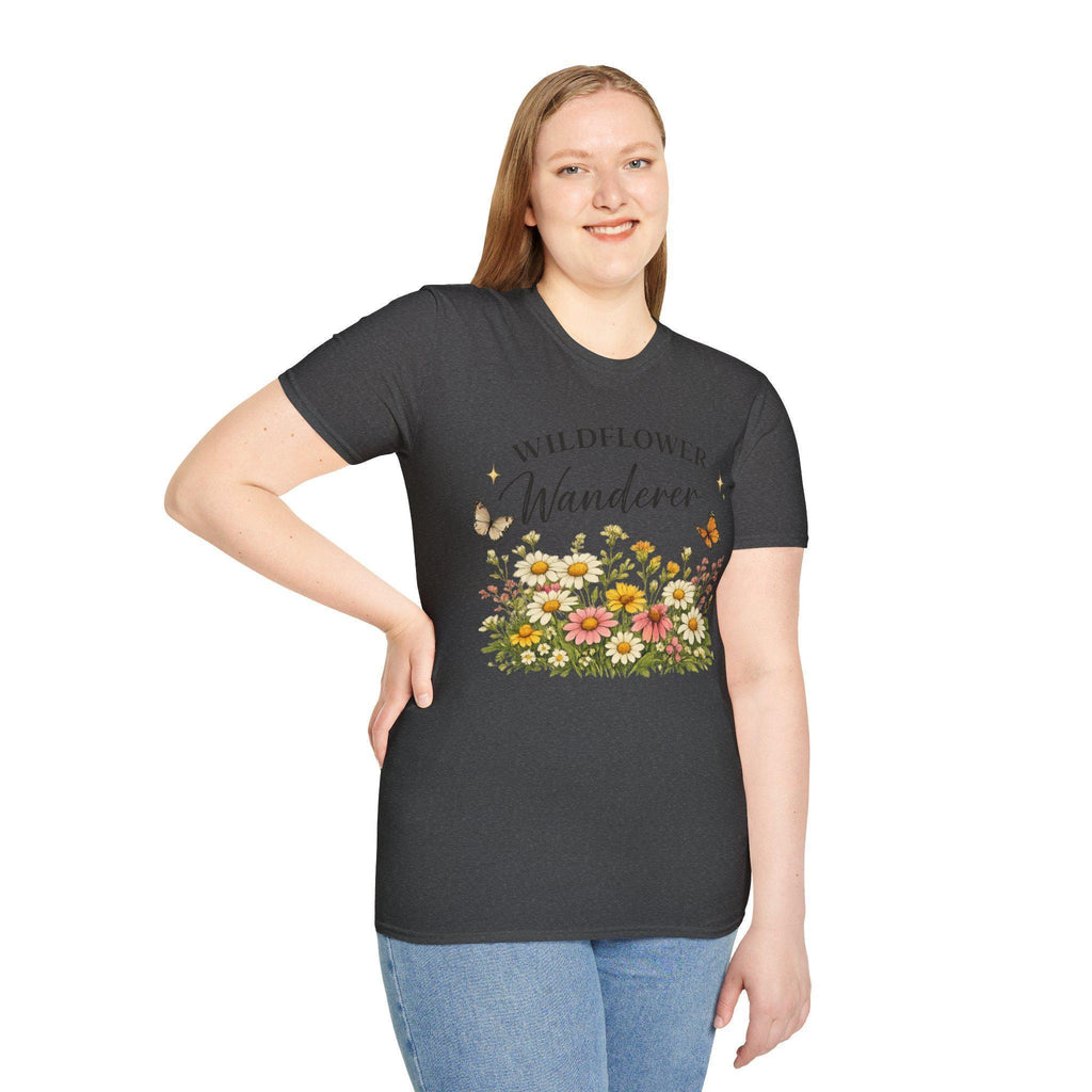 A woman with blonde hair wears a dark gray t-shirt with a colorful graphic of wildflowers and butterflies, and the text "WILDFLOWER Wanderer" on the front.
