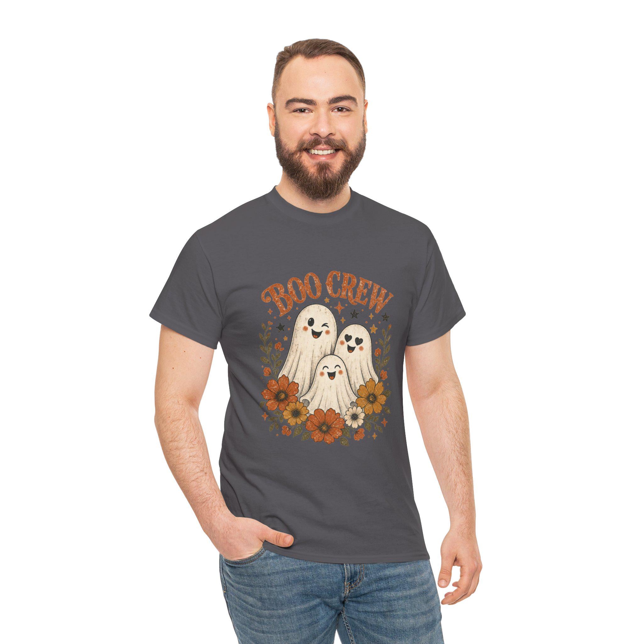 A man with a beard and short brown hair smiles, wearing a dark gray t-shirt with "BOO CREW" and three smiling ghosts surrounded by orange and brown flowers.