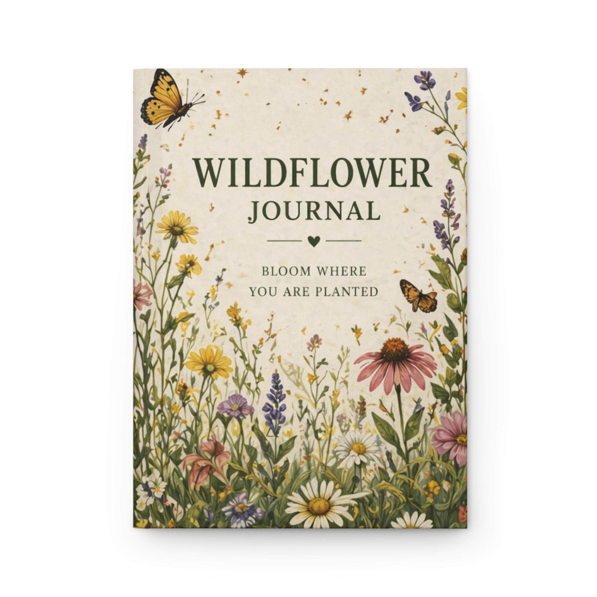 A journal with a cream-colored cover featuring a wildflower meadow design and the text "Wildflower Journal, Bloom Where You Are Planted".