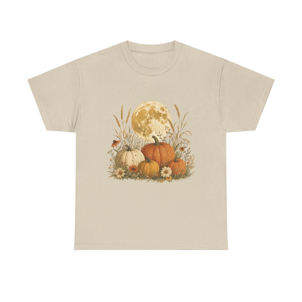 A light beige t-shirt with a graphic of a full moon behind a patch of pumpkins, tall grass, and flowers.