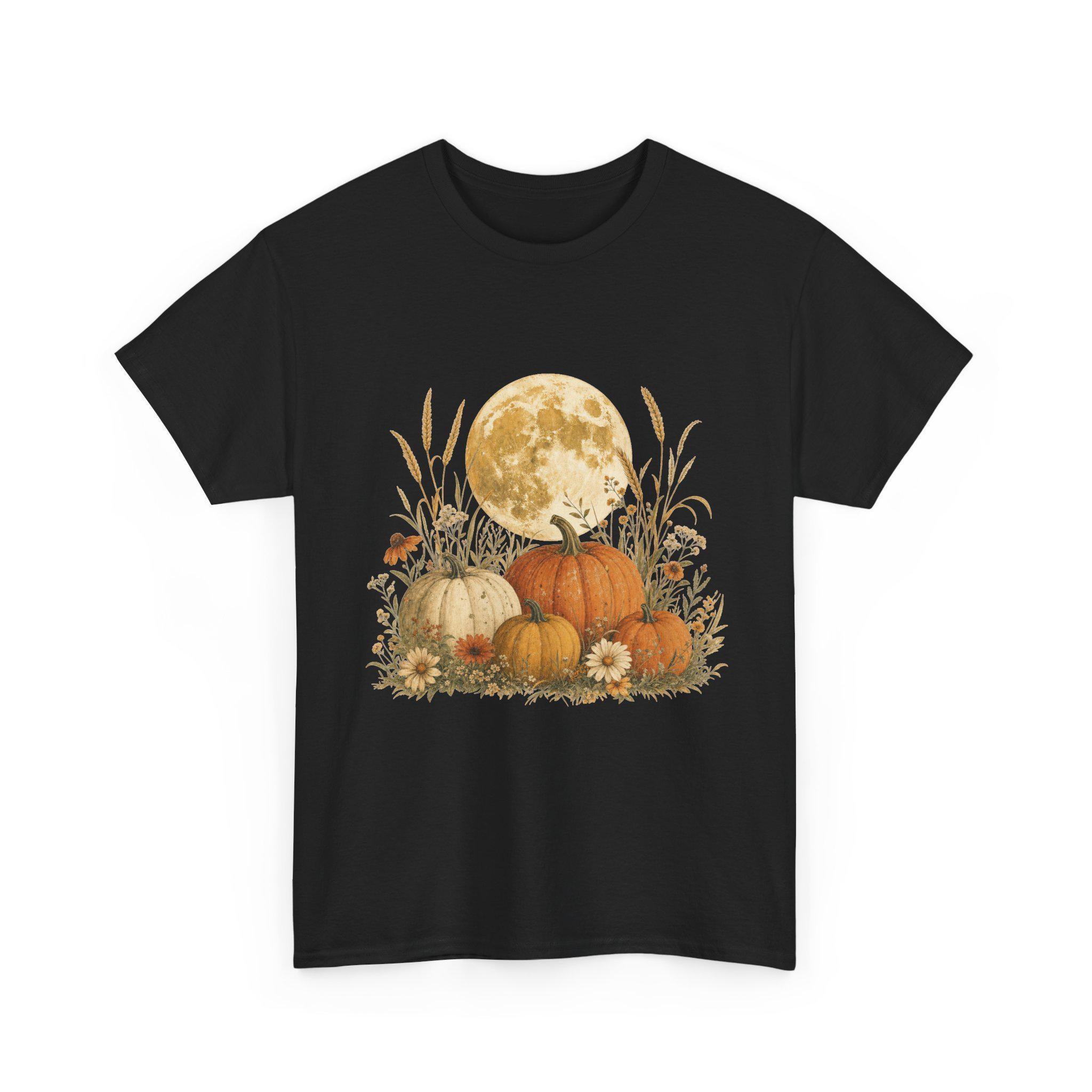 A black t-shirt displays a graphic of a large full moon behind a cluster of pumpkins, tall grasses, and small flowers.