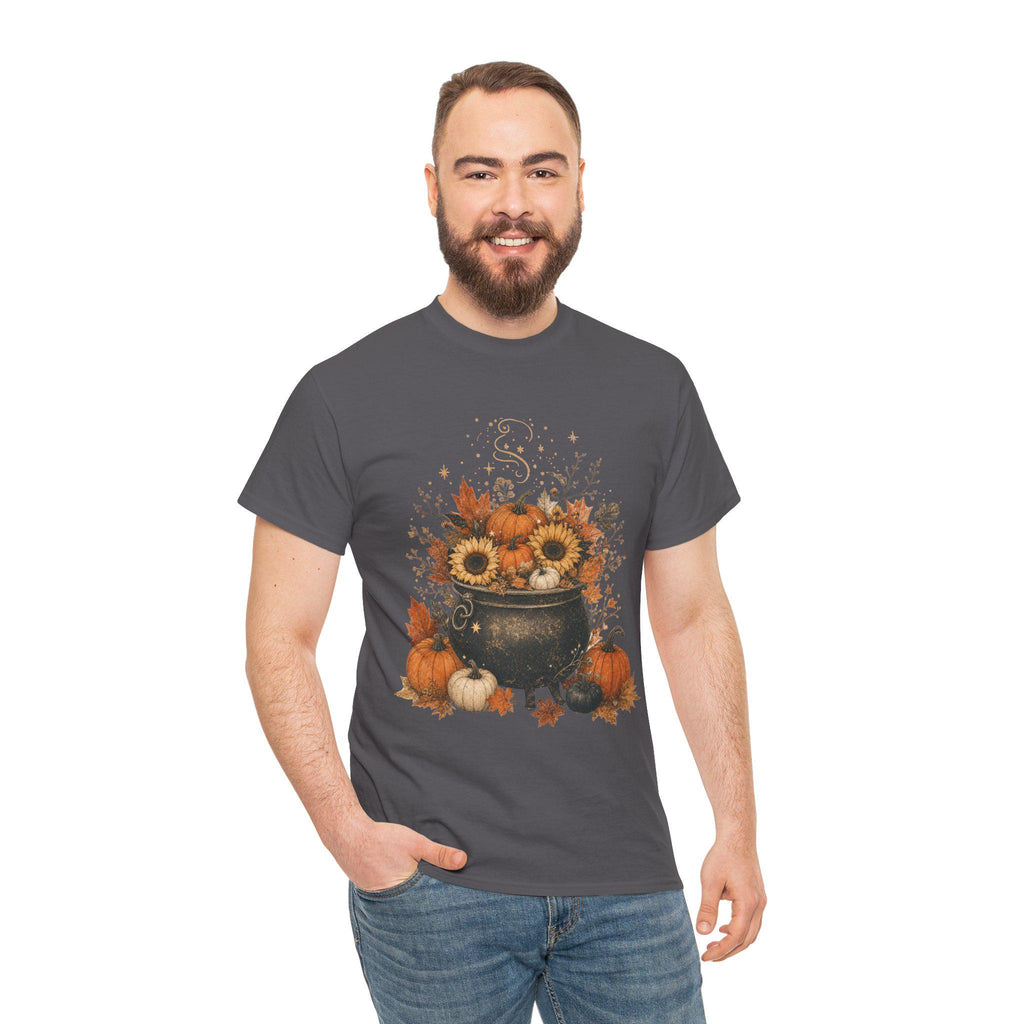 A man with a beard smiles while wearing a dark gray t-shirt with a graphic of a black cauldron filled with pumpkins, sunflowers, and autumn leaves.