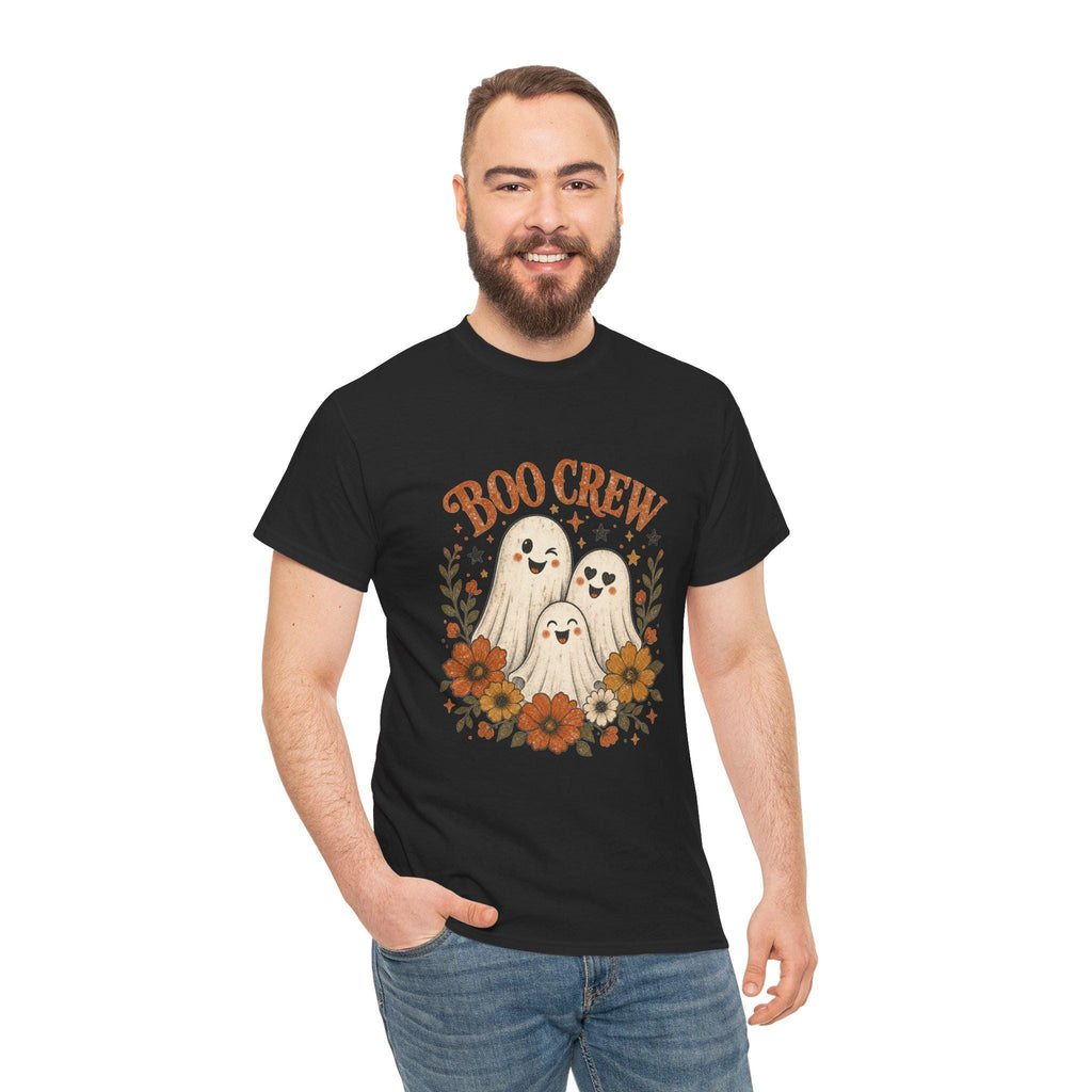 A man with a beard and short brown hair smiles, wearing a black t-shirt with "BOO CREW" and three smiling ghosts surrounded by orange and brown flowers.