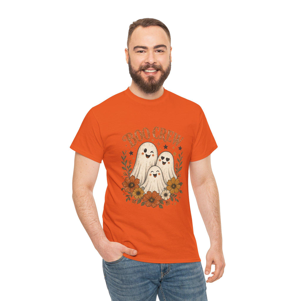 A man with a beard and short brown hair smiles, wearing an orange t-shirt with "BOO CREW" and three smiling ghosts surrounded by orange and brown flowers.