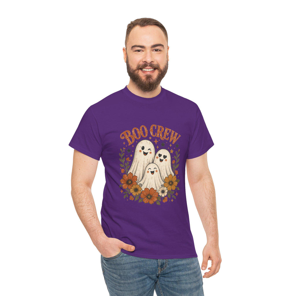 A man with a beard and short brown hair smiles, wearing a purple t-shirt with "BOO CREW" and three smiling ghosts surrounded by orange and brown flowers.